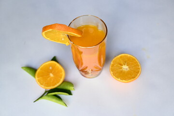 Fresh Orange juice on white background. It is a famous fruit juice which contains lots of vitamins like vitamin C, folate and potassium. Healthy drink. Fruit juice.
