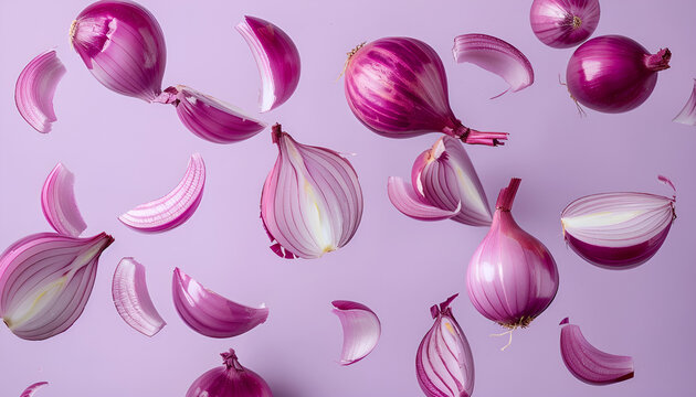 Whole and cut fresh red onions falling on light violet background