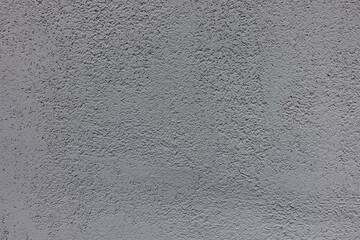 Close view of gray wall with coarse roughcast finish
