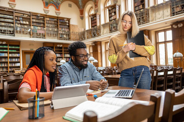 Team of students looking involved and interested while working in the library
