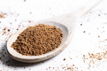 Coconut palm sugar on a wooden spoon isolated on white background