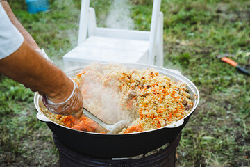 Enjoy the process of cooking outdoors as you hand stir a large pot of delicious pilaf over an open...