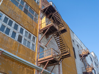 External stairs of industrial buildings. Escape ladders outside industrial buildings. Steel stairs...