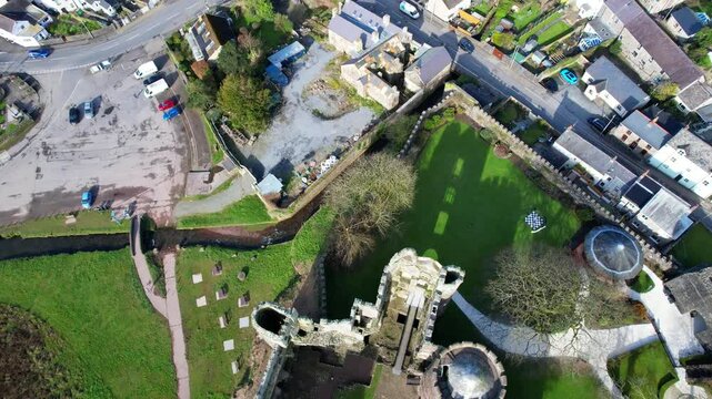 Aerial top down view of Laugharne Castle and Coran River in Wales. Backwards