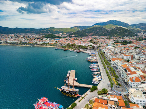 Aerial view of boats in bay with cityscape and mountains, Marmaris, Turkey.