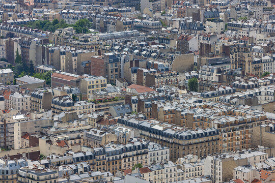 Aerial view of dense historic buildings and famous Parisian rooftops, Paris, France.