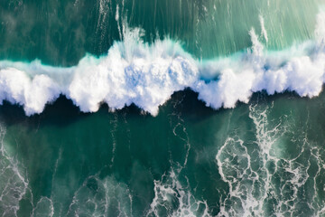 Aerial view of crashing waves along the coastal shoreline, Western Cape, South Africa.