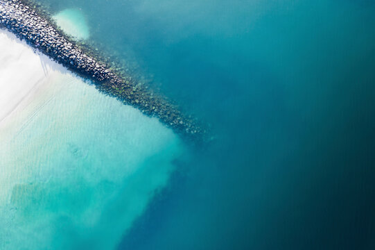 Aerial view of serene beach with crystal clear ocean and coastal landscape, Dubai, United Arab Emirates.