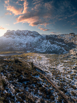 Aerial view of snow-covered mountains and serene valley under majestic sky, Ceres, South Africa.