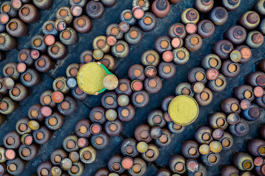 Aerial view of traditional soy sauce manufacturing with clay urns and soya beans, Ban Yen Nhan, Vietnam.