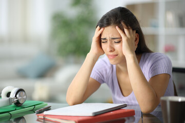Worried student complaining alone at home