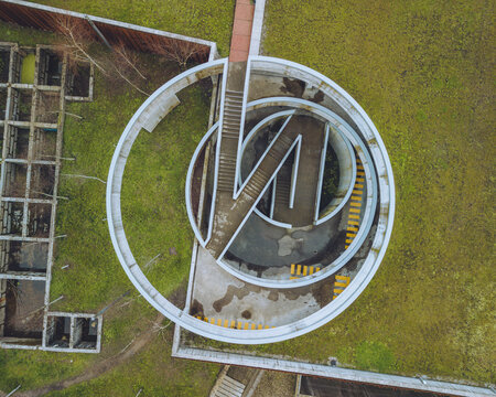 Aerial view of circular structure and car park with spiral pathway and greenery, Camoes Car Park, Guimaraes, Portugal.