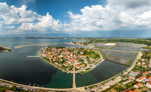 Aerial view of city, lake, bridge, buildings, and mountains by the water, Nin, Zadar County, Croatia.