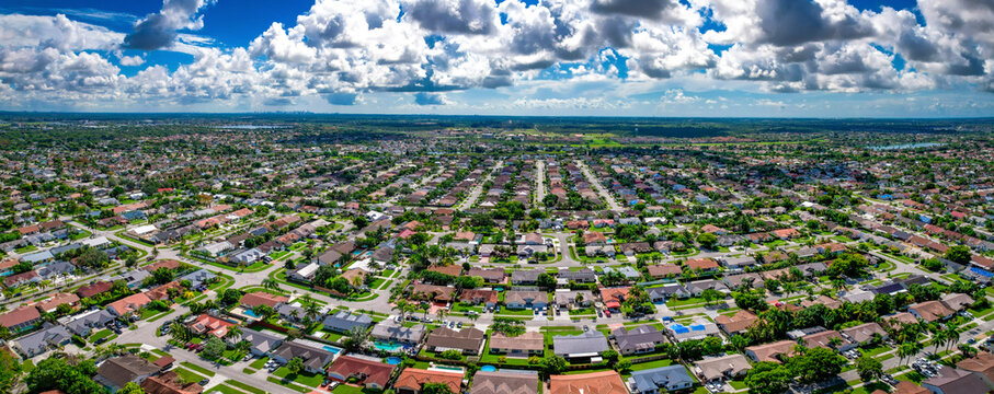 Aerial view of residential neighborhood with houses, streets, and trees under sunny skies, Richmond West, Miami, United States.