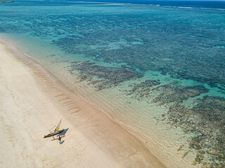 Aerial view of tranquil paradise beach with outrigger boat, Anakao, Madagascar.
