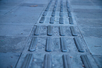 Guide path for the visually impaired so they can walk on the pedestrian walkway. Braille blocks,...