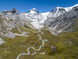 Aerial view of Chandi mountain in serene valley with snow-covered mountains and glacier, Gamghadi, Mugu, Nepal.