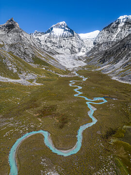 Aerial view of Chandi mountain and winding river in snowcapped valley, Mugu, Gamghadi, Nepal.