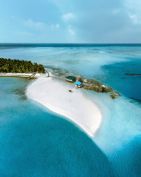 Aerial view of remote tropical island with blue ocean and sandy beach, Balabac, Philippines.