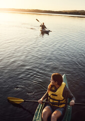 Couple, kayaking and boat on lake outdoor for sport adventure or nature travel trip. Man and woman together for sunrise workout, morning relaxation and rowing on river or water on holiday or vacation