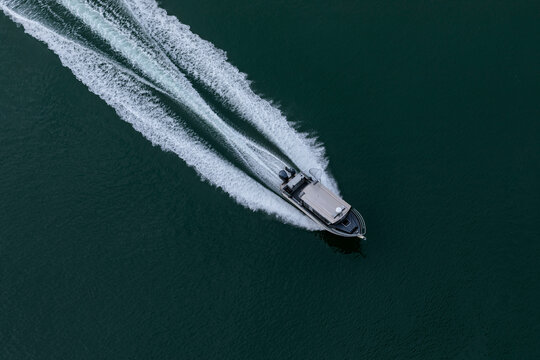 Aerial view of boat sailing on smooth water at Deception Pass, Oak Harbor, Washington, United States.