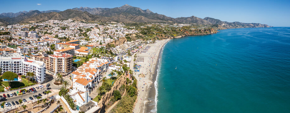 Aerial view of beach, buildings, ocean, mountains, and city, Playa de Burriana, Nerja, Andalusia, Spain.