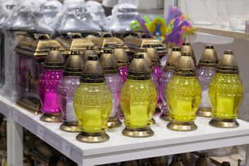 Memorial lamps of various colors are sold in store. Christian memorial lamps in shop.