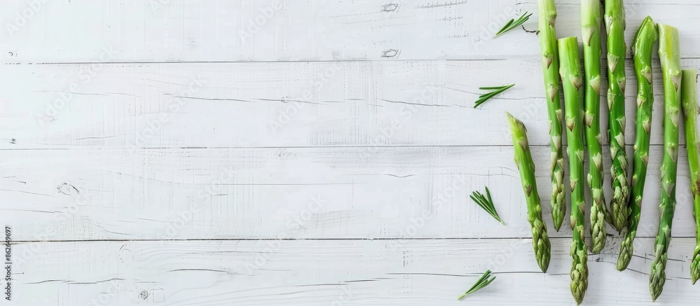 Aufkleber scandinavian-inspired top-down view mockup featuring fresh green asparagus on a white wooden table, 