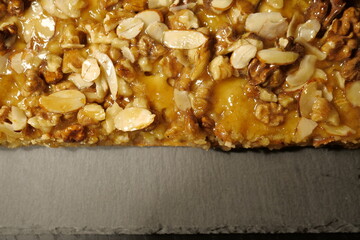 delicious tart with hazelnuts, almonds and caramel. pie with nuts. sweet pastry. close-up of a beautiful shiny cake