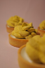 elegant shortcrust pastry tarts. cream flower. matcha flavor. green decor. pastry, desserts and sweets. modern european confectionery