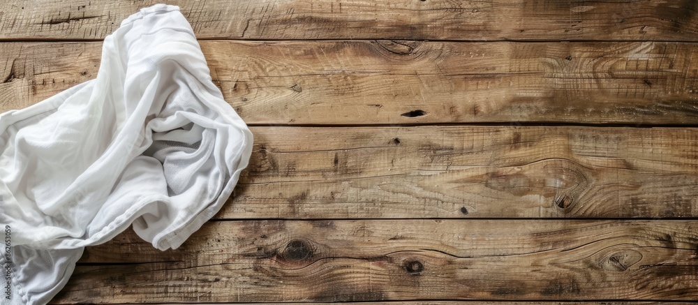 Aufkleber A kitchen towel or napkin is placed on a rustic wooden table in an overhead view, offering copy space in the image.