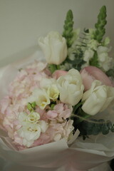 girly, cute, tender, beautiful bouquet. green, white and pink flowers. tulip, ranunculus, hydrangea, eucalyptus branches