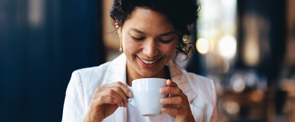 Businesswoman enjoying a coffee break in smart casual attire