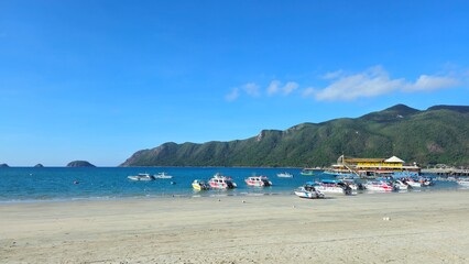 Luxury yacht club and the pier in  at Con Son island, Vietnam in the morning. Yachts in the marina with mountain view.
