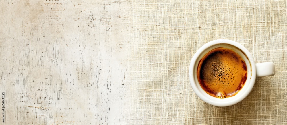 Poster a small cup of coffee sits on the table next to a copy space image.
