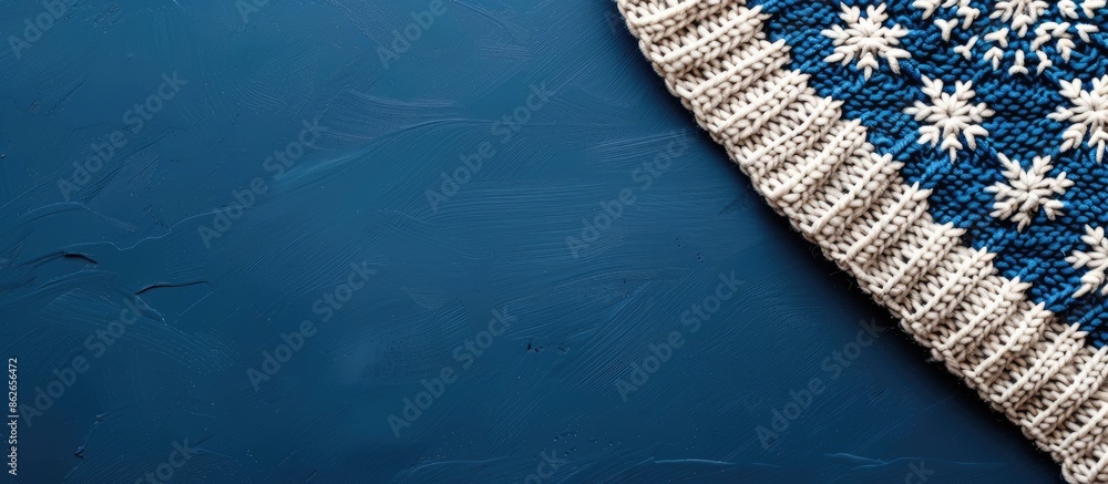 Poster Scandinavian-style knitting pattern on a blue backdrop with copy space image.