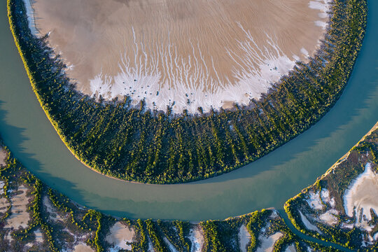 Aerial view of meandering river and lush vegetation in Gin Arm Creek, Gulf of Carpentaria, Queensland, Australia.