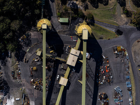 Aerial view of organized coal mining facility with machinery and towers, Dora Creek, New South Wales, Australia.