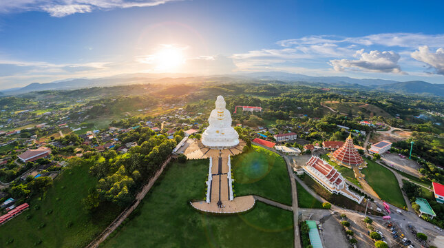 Aerial view of Wat Huay Pla Kang, Goddess of Mercy at sunset with scenic landscape, Mae Yao, Chiang Rai District, Thailand.