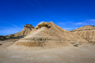 Dry desert landscape with blue sky in Bardenas reales national park, Navarro, Spain.