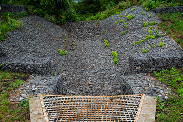 Utilizing a gravel drainage channel with a metal grate is an environmentally friendly method to...