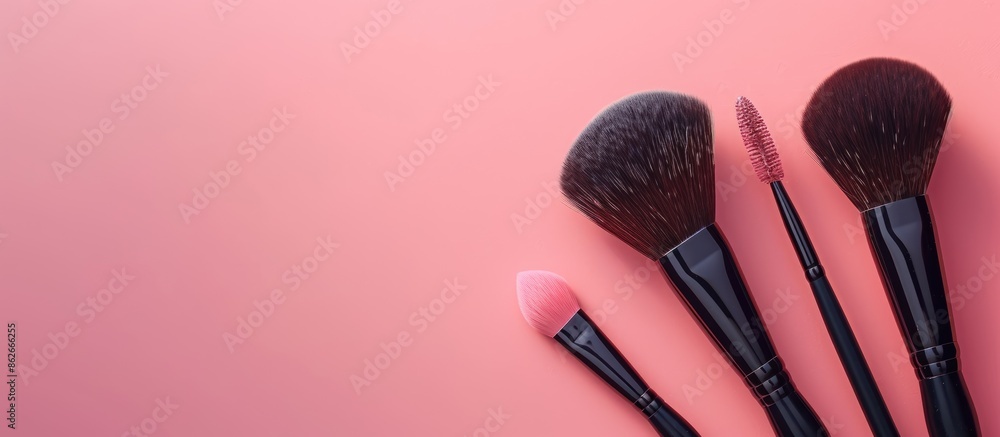 Poster Glamorous makeup brushes displayed on a soft pink backdrop in a cosmetics store banner, showing visagist tools from a top view with a creative flat lay and copy space image.