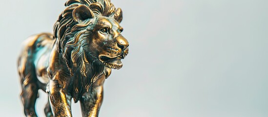 Close-up vintage lion figurine in bronze and brass on a white background for interior decoration, providing copy space for images or text.