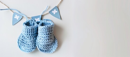 Knitted baby booties displayed on a white background with a banner indicating 'copy space image.' Handcrafted with crochet techniques.