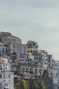 View of picturesque village with terraced houses and cliff overlooking the sea, Amalfi Coast, Italy.