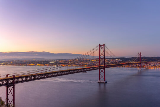 View of 25 of April bridge at sunset with Lisbon skyline, Lisbon, Portugal.