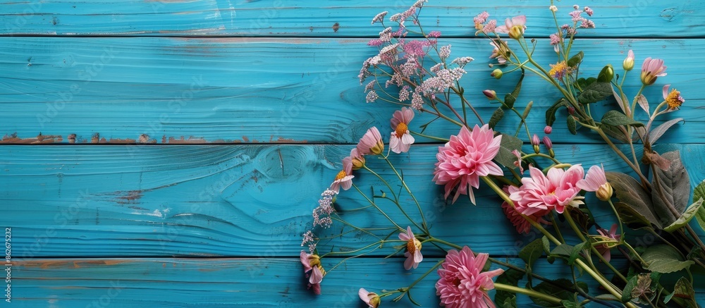 Poster floral arrangement on blue wooden boards. ideal for adding text to the copy space image.
