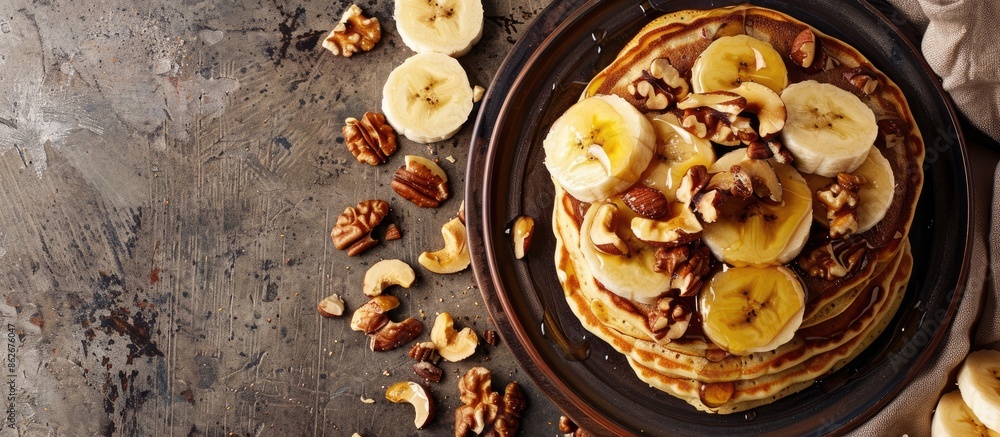 Poster Walnut and banana pancakes displayed on a table with copy space image.