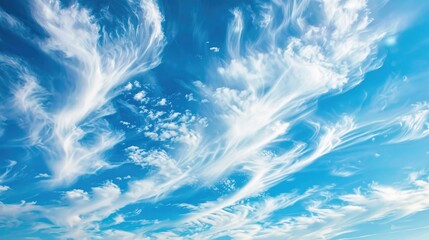 Cirrus clouds drifting across a blue sky in summer nature scene