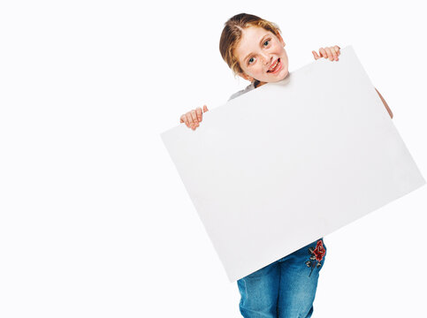 Poster, happy and portrait of girl on a white background for news, announcement and information. Back to school, advertising and child with sign, space or banner for sale, deal and bargain in studio